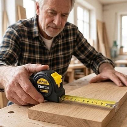 Metre ruban tenu par un homme mesurant une planche en bois