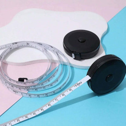 Metre ruban blanc dans sa boite cylindrique noire