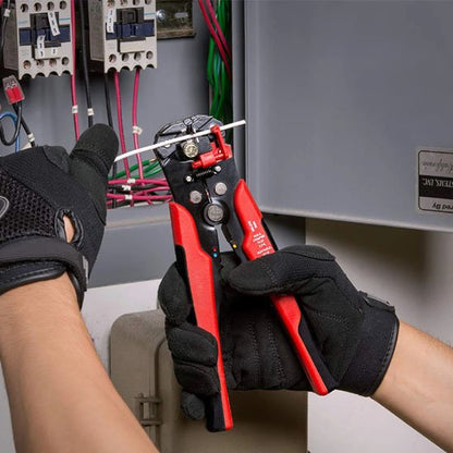 Pince à dénuder avec un électricien qui travail sur un poste électrique
